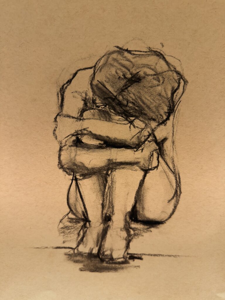 A charcoal sketch of a person curled up.